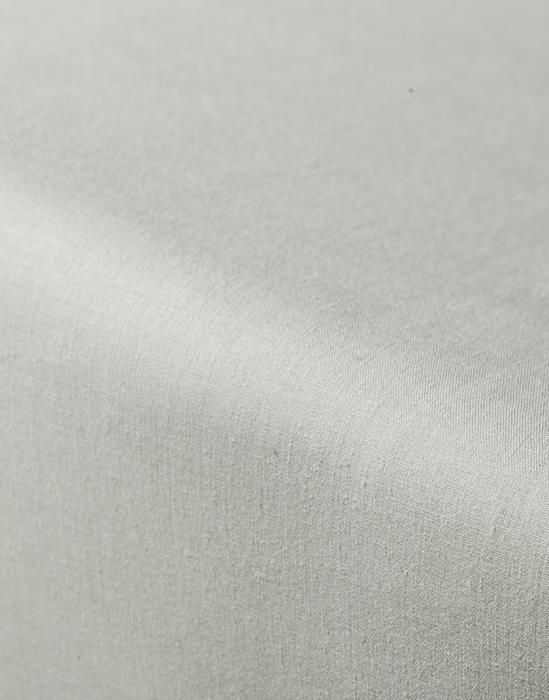 Close-up van petrolkleurig percal hoeslaken toont de fijne textuur.