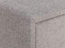 Detail van lichtgrijze nachttafel ANNA, van gestoffeerd textiel met zachte textuur.