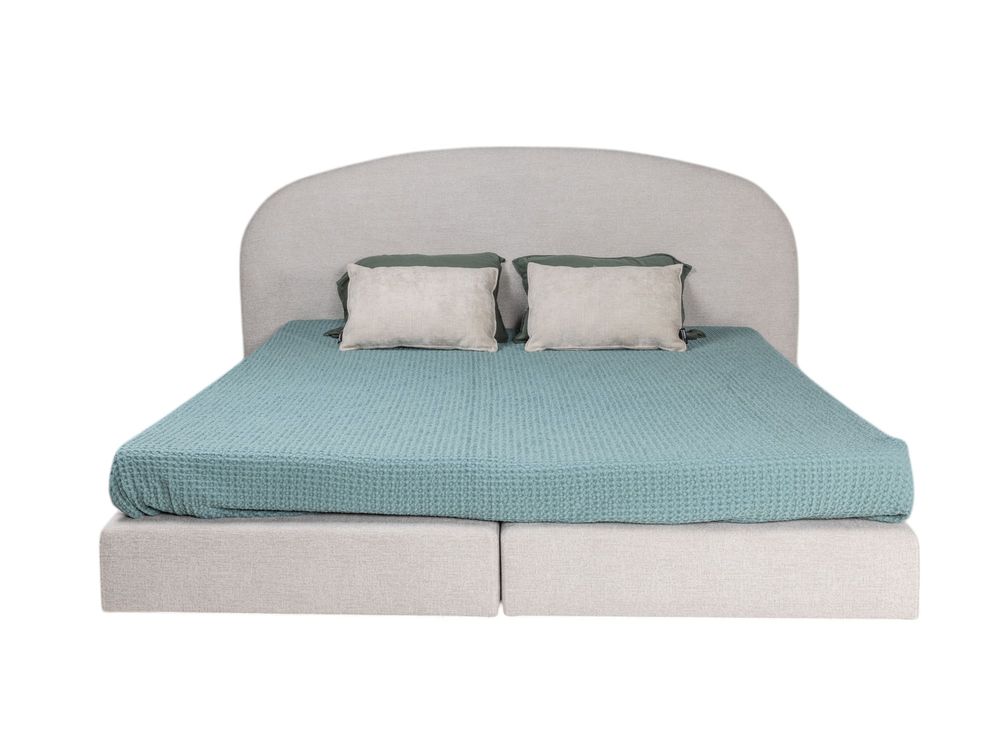 Boxspring ASPEN met beige stoffen bekleding en gestoffeerd hoofdbord.