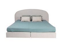 Boxspring ASPEN met beige stoffen bekleding en gestoffeerd hoofdbord.